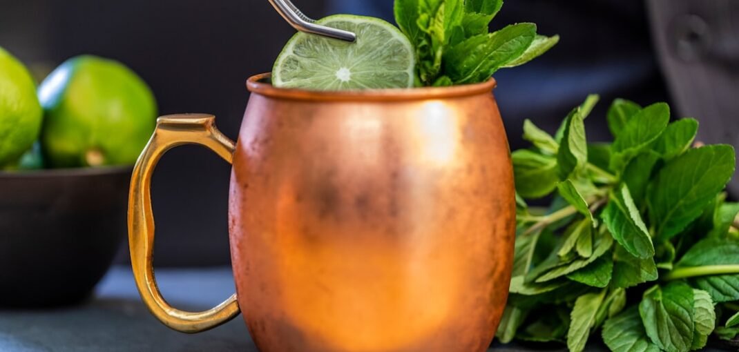 brass-colored mug with sliced lime
