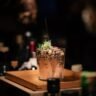 Margarita cocktail with salt rim, fresh lime wheel, and Patron Silver tequila on winter table setting