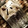 Bottle of Roku Gin with Japanese botanical ingredients including yuzu, sakura flower, and hinoki wood reflected in winter glassware