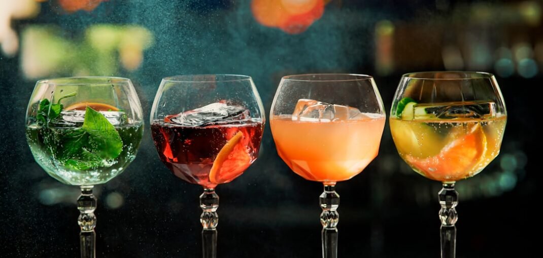 A selection of premium alcohol gift ideas arranged on a wooden surface, including whisky, gin, and wine bottles