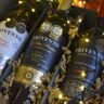 A curated selection of premium wine bottles arranged on a wooden surface ready for wine delivery NZ